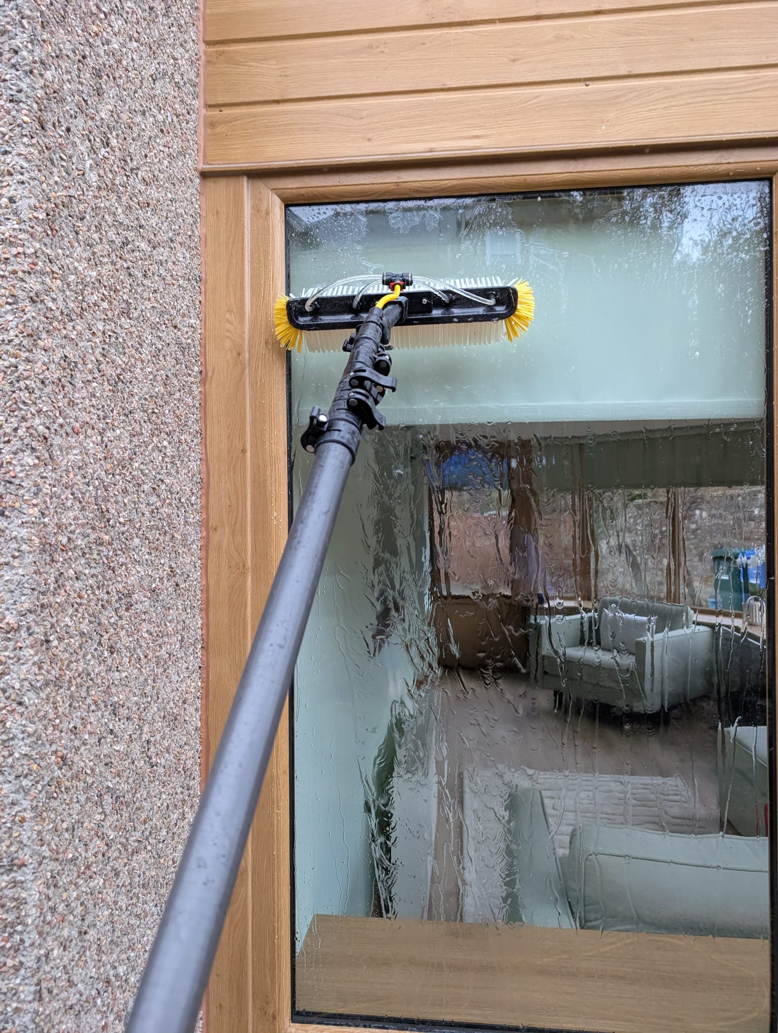 Detailed window cleaning work using professional brushes and equipment