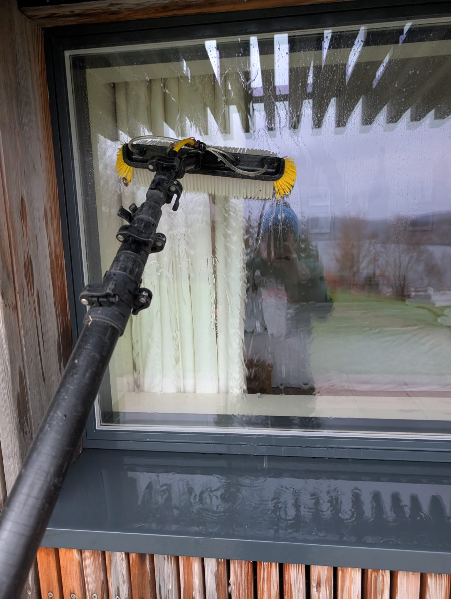 Detailed window cleaning with soap and professional brush system